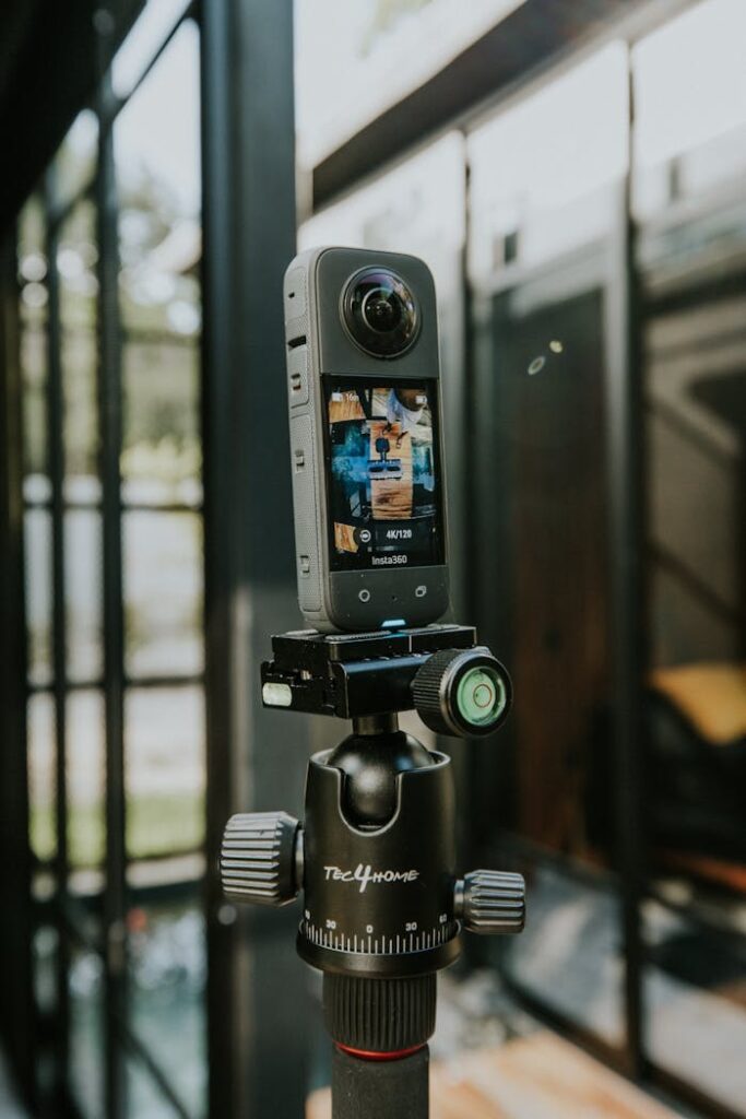 pexels photo 18868649 A 360-degree camera mounted on a tripod outdoors in a modern styled location.